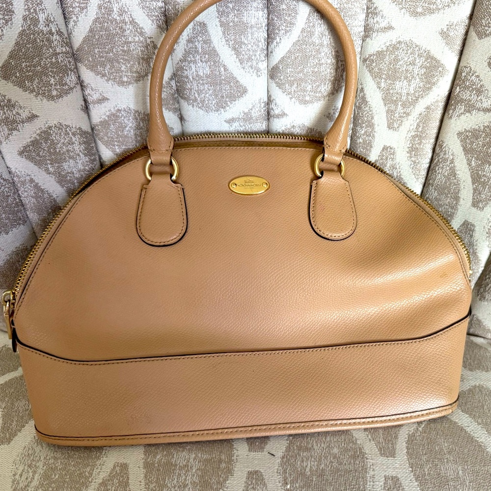 Coach Tan Leather Handbag. Zipper closure with gold accents.